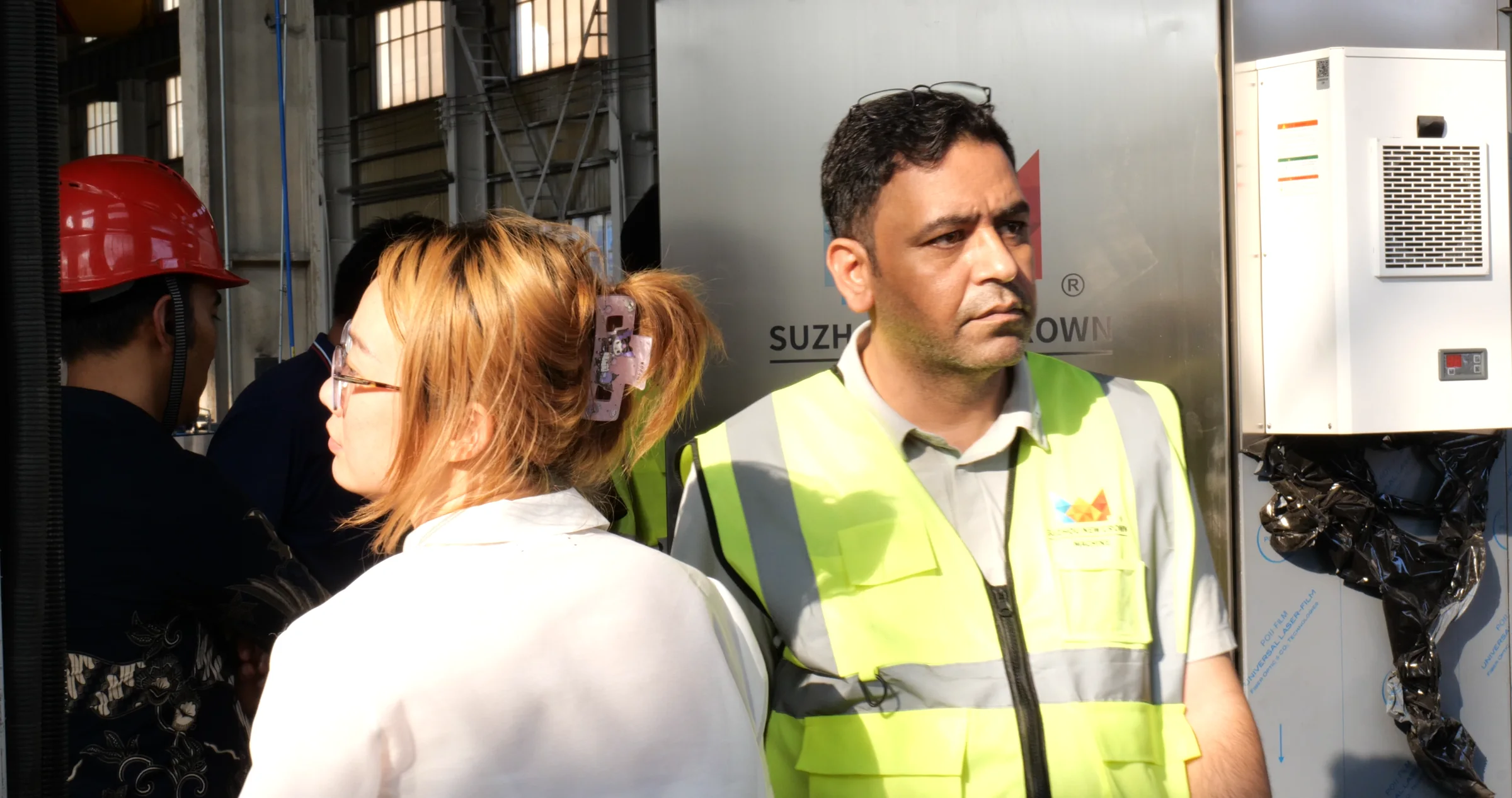 New Crown chief engineer beside beverage-line equipment