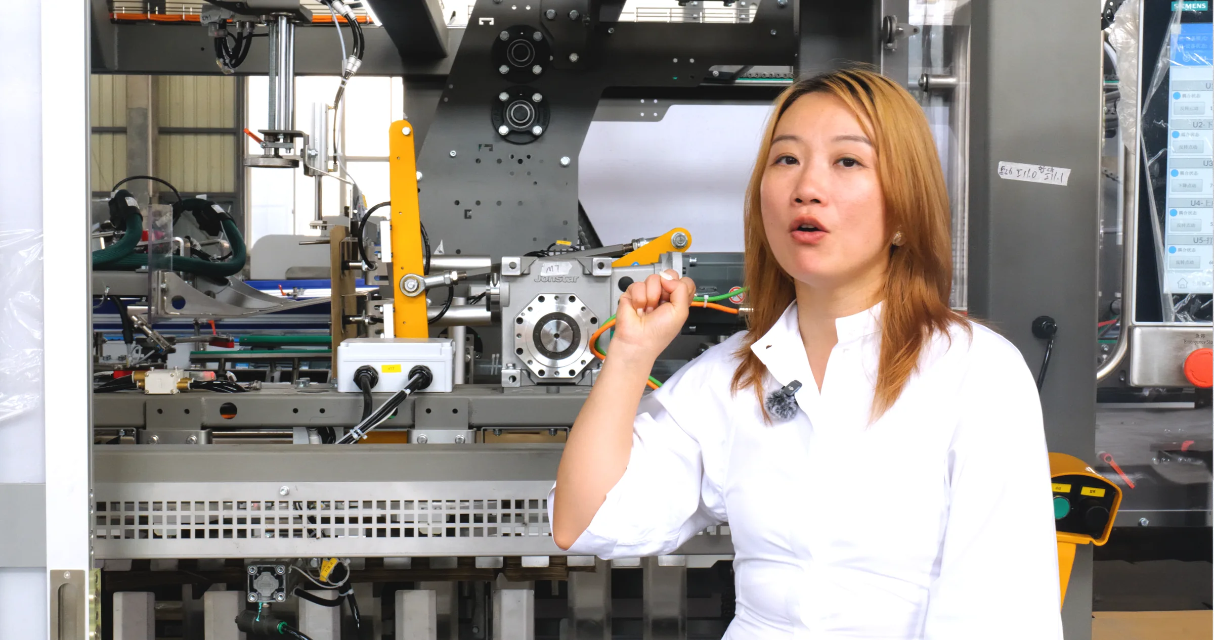 New Crown managing director beside an equipment assembly station